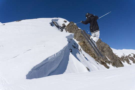 Ski rider jumping on mountains. Extreme ski freeride sport.