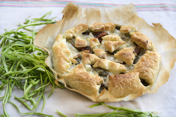 savory tart stuffed with vegetables on baking parchment