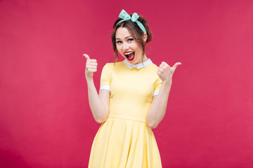 Cheerful excited pinup girl showing thumbs up
