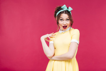 Amazed happy pinup girl in yellow dress