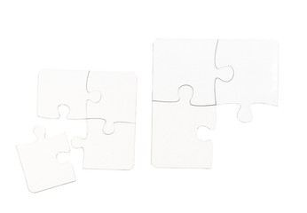 different size pieces of white puzzle isolated on a white background