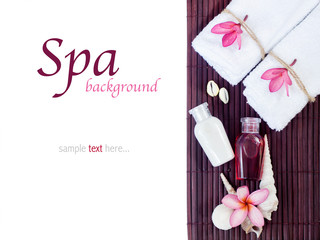 Spa background with shampoo bottles, white towels, tropical flow