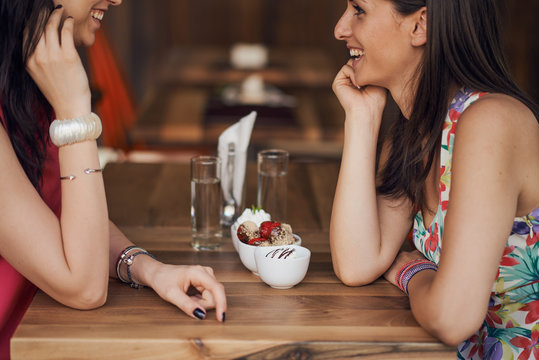 Two Girls In A Coffee Shop, Smiling, Drinking Coffee, Chatting