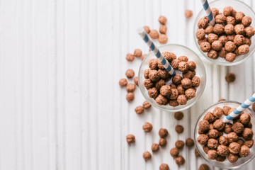 Chocolate cereal balls with milk and straws