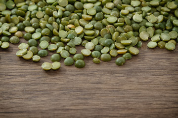 Green split peas isolated on wooden background