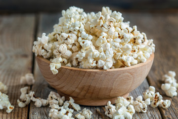 Wooden bowl with popcorn closeup.