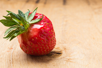 Red fresh strawberry fruit on wooden table.