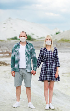 The man and the woman in respirators. Protection against viruses.