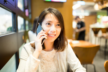 Woman chat on mobile phone at coffee shop
