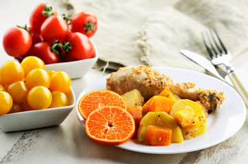 chicken drumstick cooked in spices with vegetables and citrus in