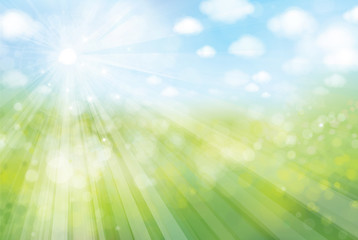 Obraz premium Vector sunshine bokeh background, green field and blue sky.