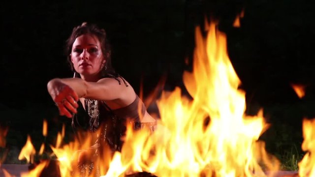 Flame and fire dancer against black background
