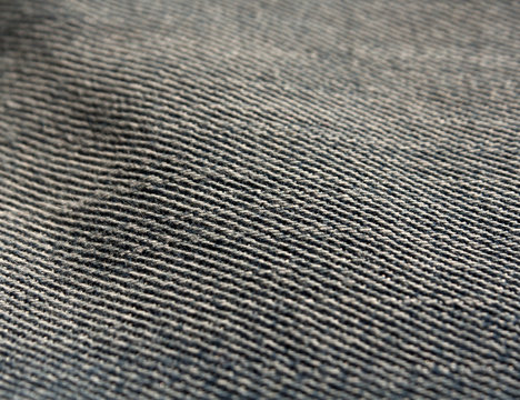 Color jeans textile texture close-up with blur effect.