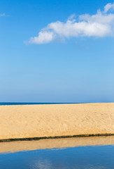 Empty tropical beach and sea with white cloud and blue sky background 