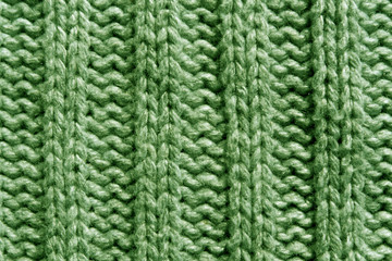 Abstract green knitting texture close-up.