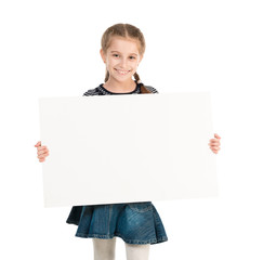 pretty smiling schoolgirl with blank sheet in hands isolated on white background