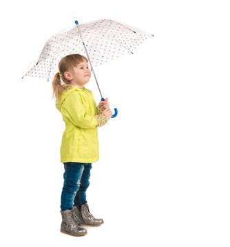 funny little girl in yellow coat holding umbrella in hand isolated on white background