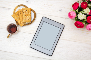 ebook and cup of tea on white boards