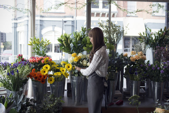 Female Florist At Work In Shop