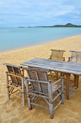 Bamboo table and chairs on sand beach