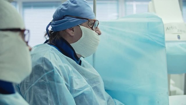 Female surgeon performing coronary artery bypass surgery assisted by nurse in operating room, shot on Sony NEX 700 + Odyssey 7Q