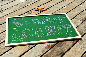 text summer camp written in a chalkboard