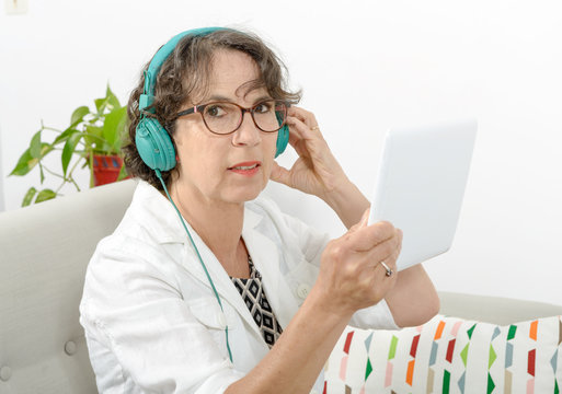 mature woman listening to music with headphones