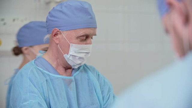 Close-up of senior surgeon and his team performing operation, shot on Sony NEX 700 + Odyssey 7Q