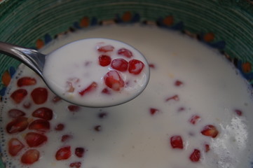 pomegranate with yogurt in a bowl