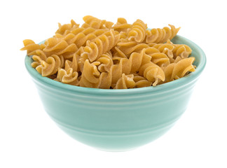 Fusilli whole wheat organic pasta in a bowl isolated on a white background