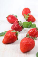 Ripe strawberries and mint on a  table
