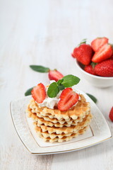 Delicious waffles with strawberries and mint