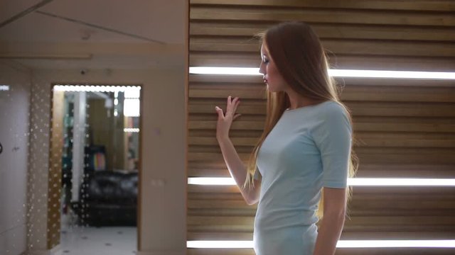 thoughtful girl walks around the apartment.