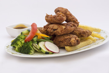 Chicken wings, salad, passion fruit spicy garnish, fries potatoes.  