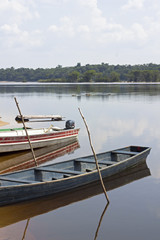 Old wooden boats moored to Amazon river shore in Brazil