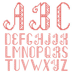Vector cross stitch alphabet isolated on white background. The letters are embroidered with red thread.