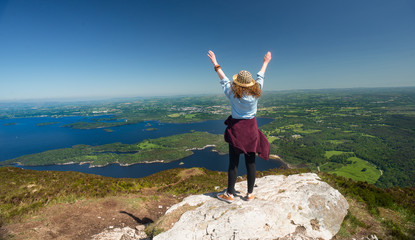 Woman celebrating getting the top of the mountain