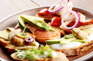 Open sandwiches with salmon, eggs, mussels, jamon and herring