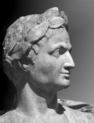 Gaius Julius Caesar sculpture on a gray background. Marble bust of  Roman general in the Summer...