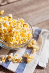 A bowl of popcorn on tablecloth