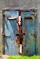 Rusty blue metal door of and old, abandoned war bunker, Sydney, Australia