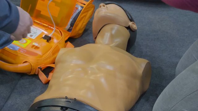 The dummy person lying on the floor it is being used to demonstrate a drill in case of a drowing emergency