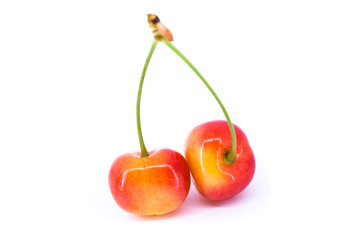 Two yellow cherries isolated on the white background