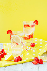 
detox , healthy and refreshing drink , lemonade, Nutritious cold sparkling water with fresh strawberry and lemon on a wooden background