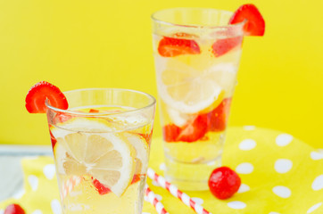 
detox , healthy and refreshing drink , lemonade, Nutritious cold sparkling water with fresh strawberry and lemon on a wooden background