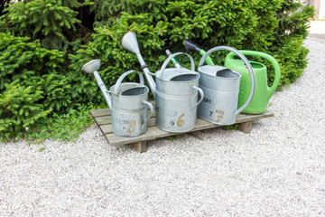 Watering cans in row