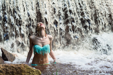 elegant woman enjoying a waterfall