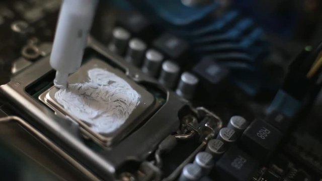 The worker applied thermal paste on the CPU