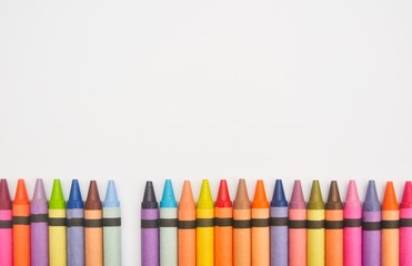 Crayons lined up in a row with one missing