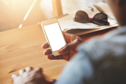 Close Up Shot Of Black Man's Hands Holding Cell Phone With Blank